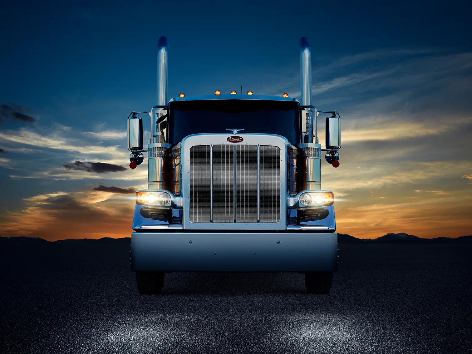 Dramatic image of the Peterbilt Model 589 set against a deep blue and gold sunset